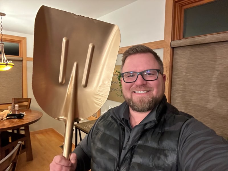 Rich Mulder, Vice President of Ozinga Renewable Energy Logistics, holding a golden shovel